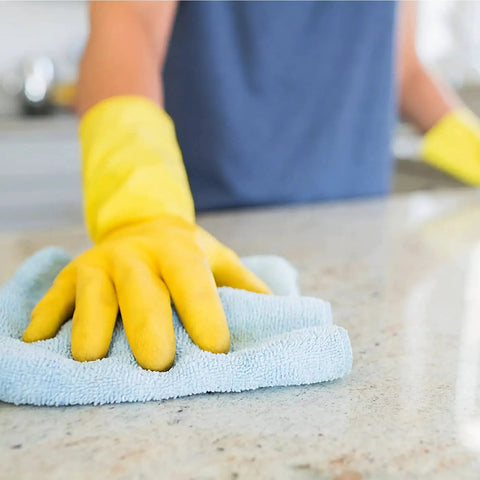 Person using a blue microfiber cloth and yellow gloves to clean a countertop with Heavy Duty All Purpose Cleaner And Degreaser One Gallon Hella Effective At Cutting Through Grease Grime And Gunky Buildup For Kitchen Countertops Appliances Walls Cabinets And Floors Works Like Butter Daily.
