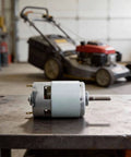 High Torque 21V DC Motor 120W For Power Tools Hand Drills And Lawn Mowers With Ball Bearings on workbench, lawn mower blurred in background.