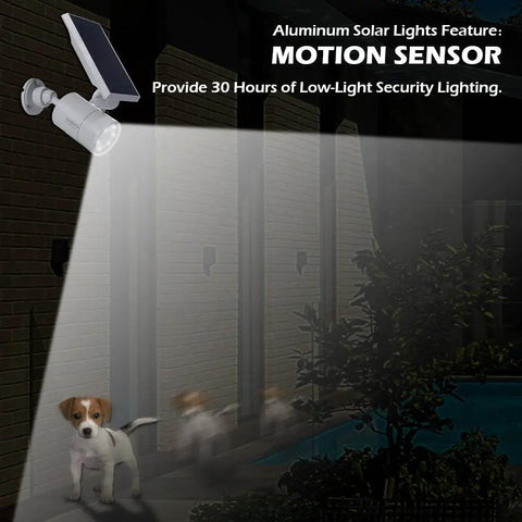 Solar Motion Sensor Flood Lights Outdoor 1400-Lumen 9W Equivalent Aluminum Security Spotlight White 2 Pack illuminating a garden