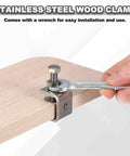 Stainless steel wood clamp with wrench for easy installation and use, mounted on wooden surface.