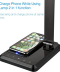 LED Desk Lamp With Wireless Charger And USB Port, black finish, with smartphone charging, shown with touch control panel