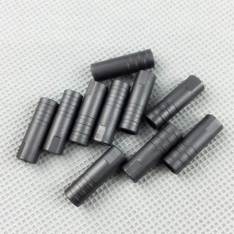 Close-up of black Bike Cable Ferrule End Caps Set For 5mm Brake Cables And 4mm Shift Cables Crimp Plastic Caps 200 Pieces on gray surface