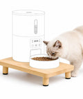 Elevated Cat Food Stand, Ergonomic Neck And Spine Care Feeding Table with a cat eating from a bowl.