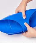 Flexible blue plastic being held, demonstrating versatility, but not the Heavy Duty Snow Sled For Downhill Thrills With A Non Slip Sanded Seat.