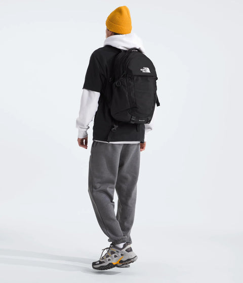 Back view of person wearing Recon Everyday Laptop Backpack For Work And School with water-resistant design and cushioned back panel.