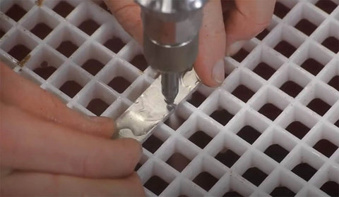 DIY metal waterjet cutting head assembly close-up with mixing chamber and nozzle