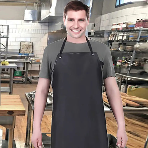 Man wearing a black waterproof rubber vinyl long work apron in a busy kitchen setting