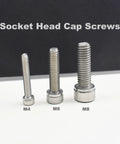 M4, M6, and M8 stainless steel hex socket cap screws displayed on a white surface for comparison.