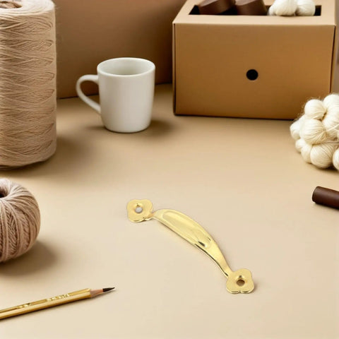 Vintage Zinc Alloy Cabinet Pull Handles 10 Pack For Wardrobes And Drawers on a craft table with yarn and cup