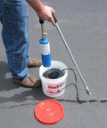 Man applying 125 Feet Of Blacktop Crack Filler For Asphalt And Concrete Weather Resistant No VOCs Pro Grade Deep Cracks And Joints