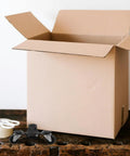 Heavy Duty 4 Pack Furniture Dollies Making Moving A Breeze Carbon Steel Frames Handling Huge Loads Without Breaking A Sweat Ideal For DIY Pros Shifting Stuff When Energy Matters Most Keeping Items Rolling Smooth Through Tight Spaces And Warehouse Rooms, black caster dolly beside box