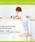 Child using the safety control switch on the Ultra Compact 600W Electric Mini Hot Plate With Nine Precise Heat Settings.