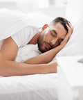 Man sleeping with All Day Comfort Corded Earplugs With 25dB NRR, Reusable Soft TPR Ear Plugs For Shooting Range Snoring Studying Construction And Manufacturing, Skin Friendly Fit, Easy In, Bright Orange.
