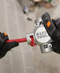 Hands using Large Cable Stripper For 2/0 To 250 MCM Cables With Clover Design for precise insulation removal on red cable.