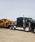 Truck with trailer transporting equipment, secured by Ratcheting Chain Binder Three Eighths To One Half Inch Four Pack Load Binders.