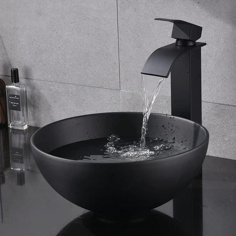 Sleek Black Vessel Sink With Drain Included, 13x13 Round Above Counter Bathroom Vanity Sink, water flowing into porcelain ceramic bowl