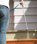 Person using 30 Inch Tip Extension With RAC V Guard For Sprayers, Great For Ceilings And Eaves, Helps You Stay Off Ladders, Includes OneSeal