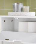 Slim Toilet Storage Cart With Wheels For Narrow Spaces 3 Tier Organizer For Toilet Paper Rolls Brushes Towels And Bathroom Essentials White Finish With Discreet Side Cabinet And Open Shelves Easy Glide Mobility BZR31-W showing open cabinet with toilet paper and decor
