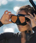 Adult wearing Crystal Clear HD Mask And Snorkel Set With Dual Lenses For Adults, Clear Vision Underwater, close-up by ocean