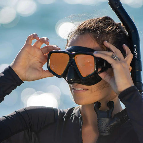 Adult wearing Crystal Clear HD Mask And Snorkel Set With Dual Lenses For Adults, Clear Vision Underwater, close-up by ocean