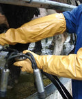 Person using Atlas 772 Double Nitrile Coated Full Arm Chemical Resistant Safety Glove handling milking equipment