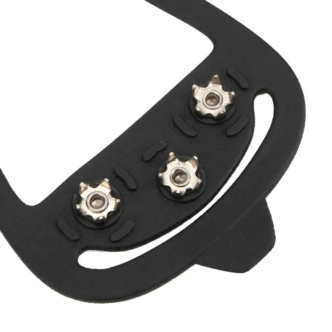 Close-up of Eight-Tooth Ice Crampons With Flexible Silicone Cover For Shoes, showing stainless steel spikes and silicone material.