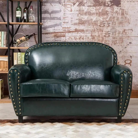 Tough As Nails Gold Metal Upholstery Tacks For Furniture Fixes And Slick Diy Upgrades 500 Pack Heavy Duty Brass Thumb Nails with rust-resistant coating on green leather sofa.