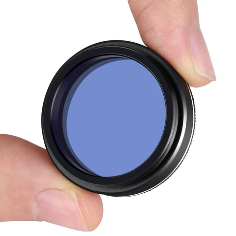 Moon And Sky Glow 1.25 Inch Telescope Filter held between fingers, aluminum construction with optical glass lens for clearer moon views.