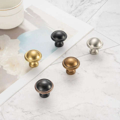 10 Pack One And A Quarter Inch Brushed Gold Cabinet Knobs For Cabinets Drawers Dressers Cupboards Sturdy Solid Metal Hardware Built To Last In Humid Kitchens And Bathrooms displayed with various metallic knobs on marble surface
