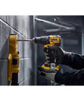 Heavy Duty 20 Volt Max Brushless Cordless Hammer Drill Driver With Rock Solid Build And Beast Mode Torque For No Sweat Concrete Work and Day One Job Site Reliability Tool Only drilling into concrete wall.