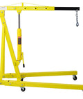 Big Iron Two Ton Folding Engine Hoist With Six Swivel Casters That Roll Like Butter For Stress Free Shop Moves And Quick Hydraulic Lifts Of Car Engines Or Truck Blocks Yellow, yellow hydraulic hoist with casters and adjustable lifting arm.