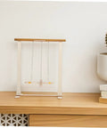Educational Wooden Gravity Experiment Kit For Kids And Students displayed on a shelf, featuring an interactive Maxwell wheel.