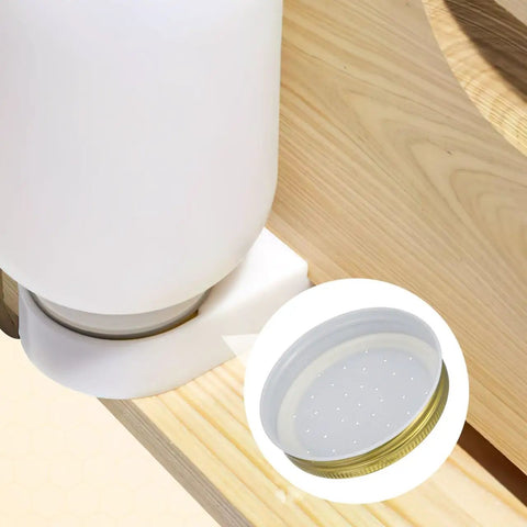 Bee Entrance Feeder For Beehives 8 Pack Perforated Metal Mason Jar Lids showing jar lid and feeder setup on wood surface