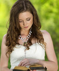 Woman wearing Blank Sublimation Rosary Beads Necklace Set Of 6 Dope White And Black Catholic Prayer Beads holding a Bible