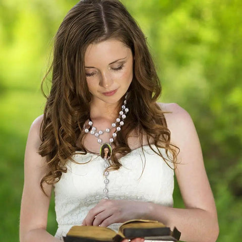 Woman wearing Blank Sublimation Rosary Beads Necklace Set Of 6 Dope White And Black Catholic Prayer Beads holding a Bible