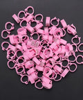 100 Pieces Pigeon Leg Bands 8mm Numbered Bird Leg Rings for Small Birds Poultry Foot Clips in pink plastic on black background
