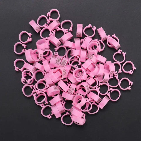 100 Pieces Pigeon Leg Bands 8mm Numbered Bird Leg Rings for Small Birds Poultry Foot Clips in pink plastic on black background