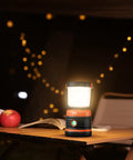 Beast Bright Rechargeable LED Camping Lantern 1800 Lumens with four light modes on a table in outdoor setting