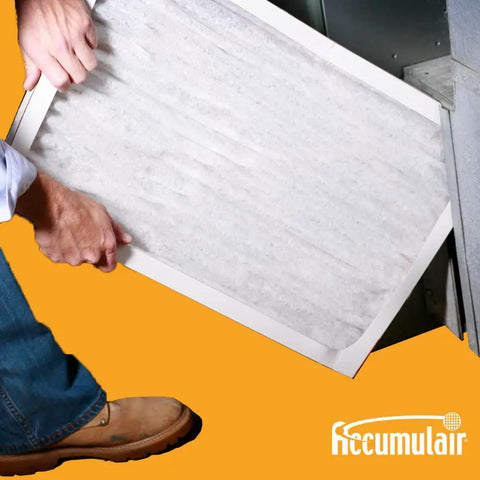 Person installing MERV 8 Pleated Replacement Air Filter 14x18x1 For AC And Furnace, high efficiency HVAC filter in unit.