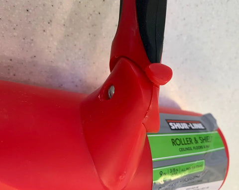 Close-up of Nine Inch Paint Roller With Integrated Anti Splatter Shield And Heavy Duty Rubber Grip for seamless wall painting.