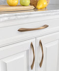Champagne bronze 5-inch cabinet pulls installed on white kitchen cabinets, part of 10 Pack 5 Inch Champagne Bronze Cabinet Pulls Set For Cabinets And Drawers Kitchen Cupboard Hardware Dresser Handles Durable Zinc Alloy Construction Smooth Satin Finish Easy Grip.