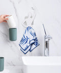 Kickass Sticky Wall Hooks Featuring A Snazzy Ballet Design deliver rock solid hold, displaying towel and cups in a bathroom setting.