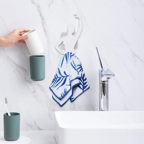 Kickass Sticky Wall Hooks Featuring A Snazzy Ballet Design deliver rock solid hold, displaying towel and cups in a bathroom setting.