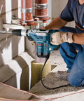 Worker using Heavy-Duty SDS Max Rotary Hammer Drill, 13 Amp, 120V on a concrete wall, showing vibration control in action