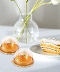 Clear Mini Cupcake Boxes With Dome Lids 100 Pack Plastic Treat Containers For Muffins Pastries And Cookies Bulk Packaging Easy To Carry For Birthday Party Supplies displayed with muffins.