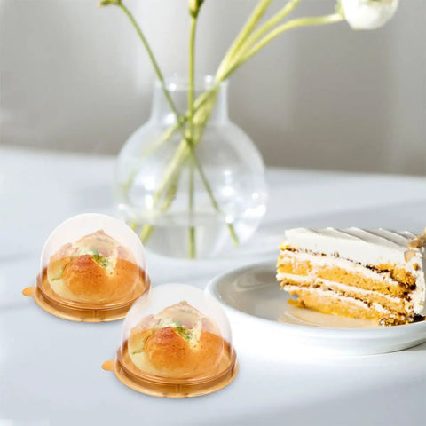 Clear Mini Cupcake Boxes With Dome Lids 100 Pack Plastic Treat Containers For Muffins Pastries And Cookies Bulk Packaging Easy To Carry For Birthday Party Supplies displayed with muffins.