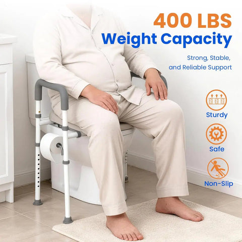Man sitting on Raised Toilet Seat With Handles For Seniors Cozy Padded Elevation Riser Comfortable 350 Pound Capacity Adjustable Handicap Toilet Riser Gray FSA Eligible Now in bathroom, showcasing weight capacity and safety features.
