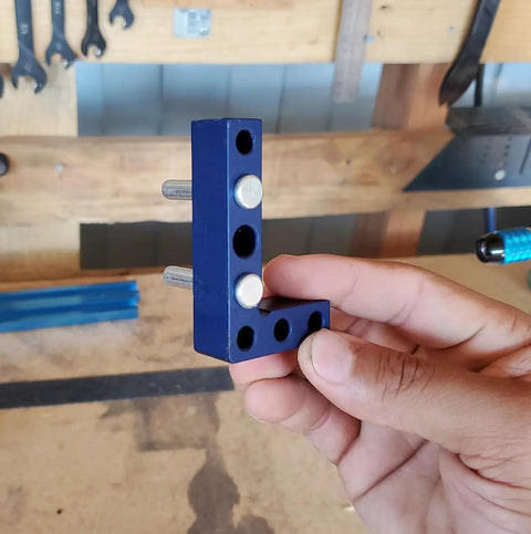 Heavy Duty Woodworking Square And Center Finder With An 11 32 Marking Hole, blue metal L-shaped tool being held.