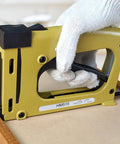 Hand using Pro Grade Point Driver For Picture Framing With 1000 Points, Heavy Duty Framing Tool For Artists And DIYers, yellow color