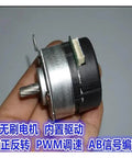 Close-up of high efficiency brushless servo motor with built in drive 9V to 24V DC PWM speed regulation, held in hand.